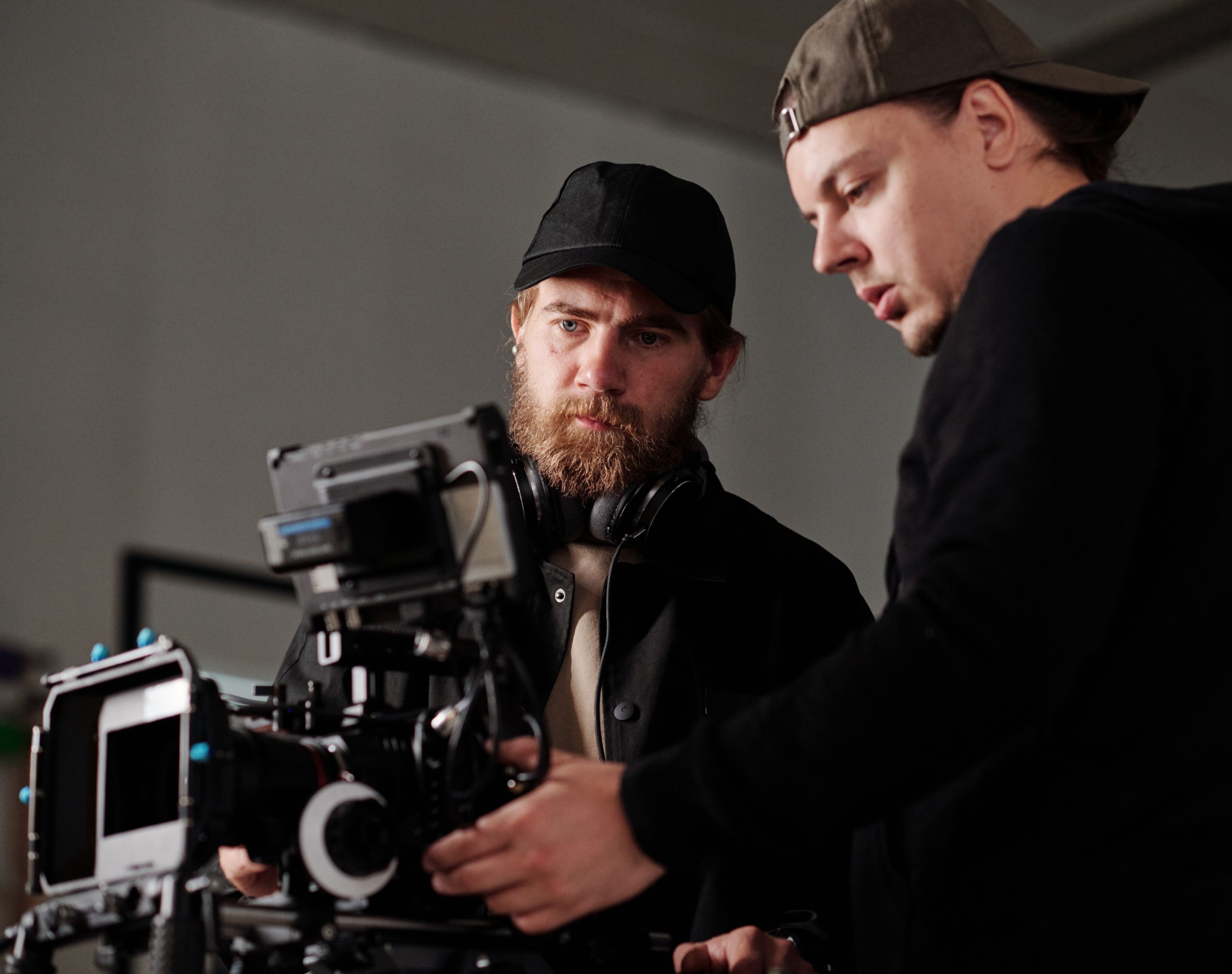 VKTWA Two men adjusting a professional camera.